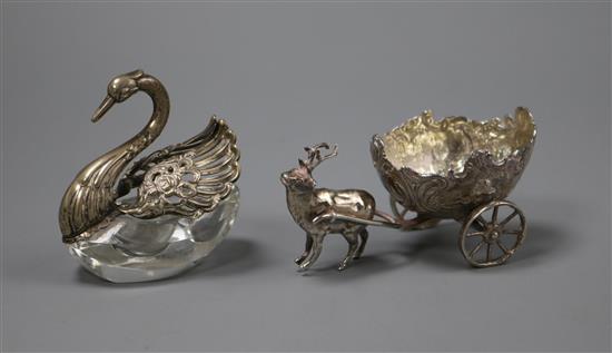 An ornate Edwardian silver table salt modelled as a stag pulling a cart, import marks for London, 1903 and a swan condiment.